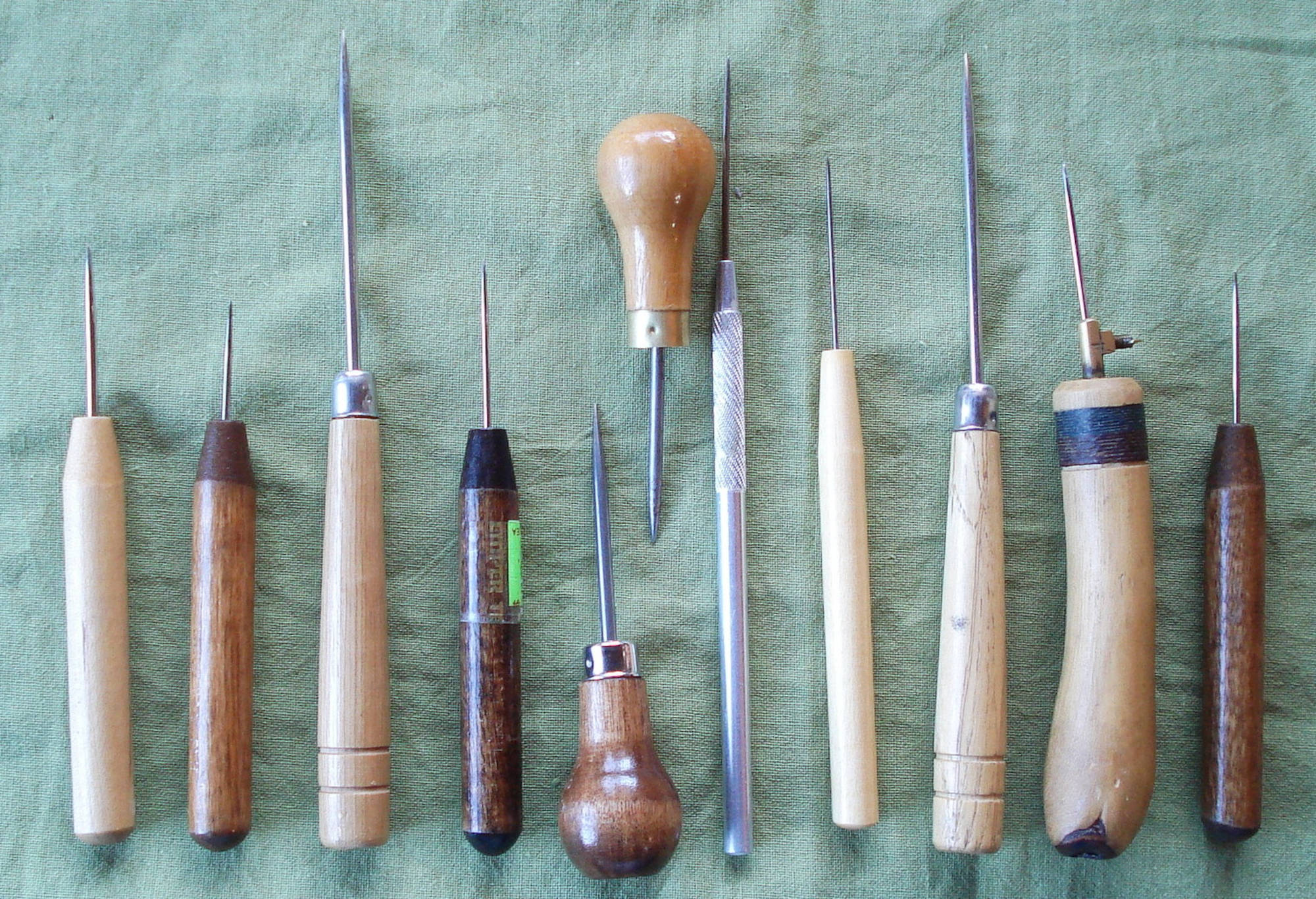 A collection of awls for preparing pages to be handsewn for making books.