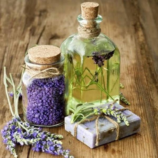 Dried Lavendar, Lavendar soap bar, Lavendar oil and small bouquet of Lavendar on wood table.