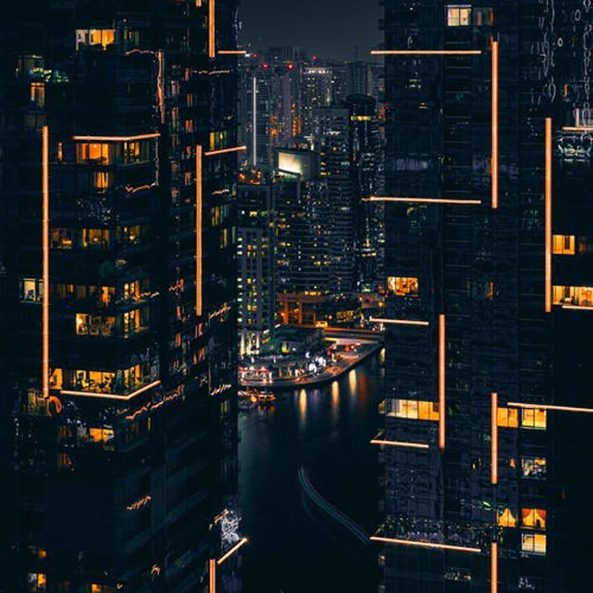 Dark shot with bright lights from densely populated city apartment buildings