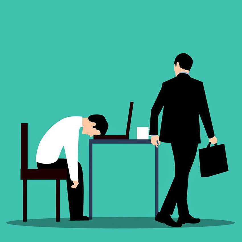 A graphic illustration of a man slumped over his laptop, asleep. A co-worker or boss looks at him as he walks by with briefcase in hand. 