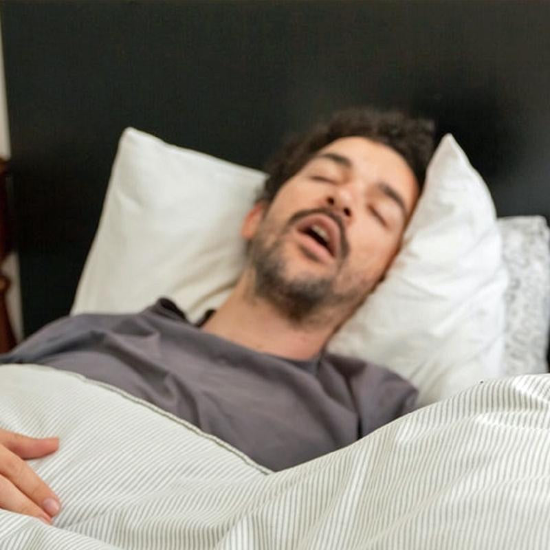 Man sleeping in bed and snoring