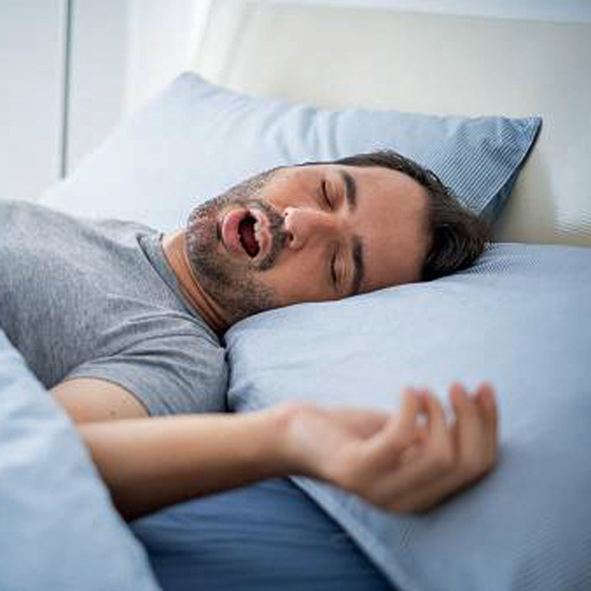 A sleeping man with his mouth wide open snoring. Noise masking blocks out snoring.
