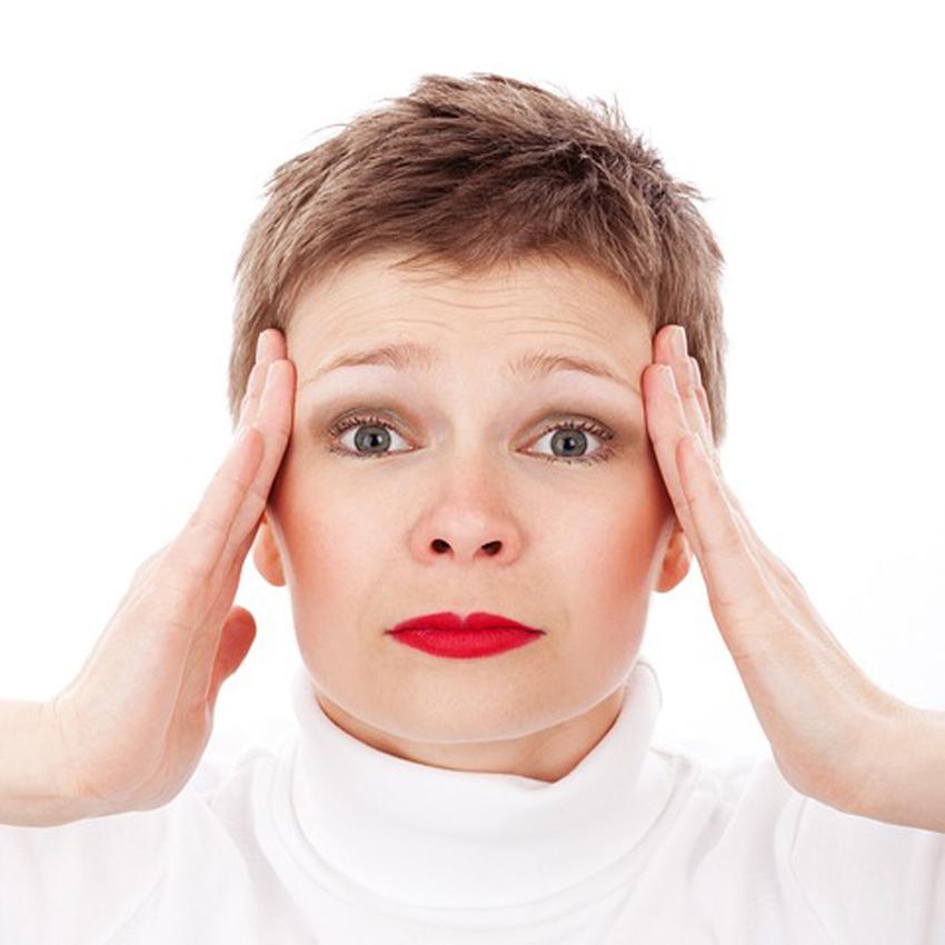 A stressed out woman holds her hands up to the sides of her head. Stress is now considered the #1 health problem.