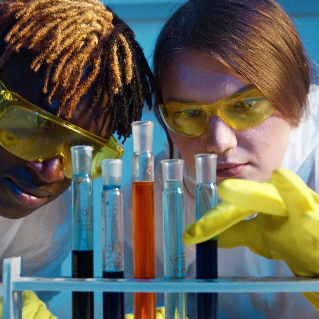 A young man and woman working in lab with test tubes. Sleep deprivation makes you more prone to infections.