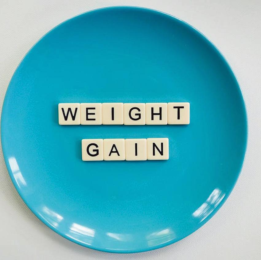 Blue Plate with Weight Gain spelled out in Scrabble tiles 