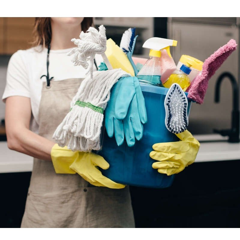 Woman holding cleaning gear