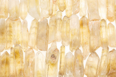 Several light yellow crystals lined up in rows