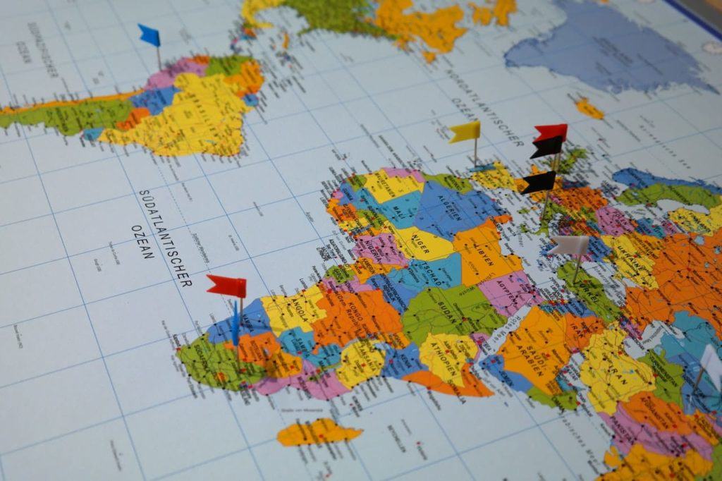 picture of a map with flags stuck in countries