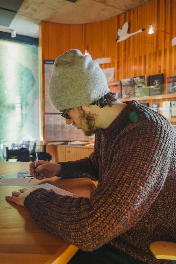 robin writing a post card