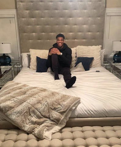 Giannis Antetokounmpo lying on his new mattress from Maree