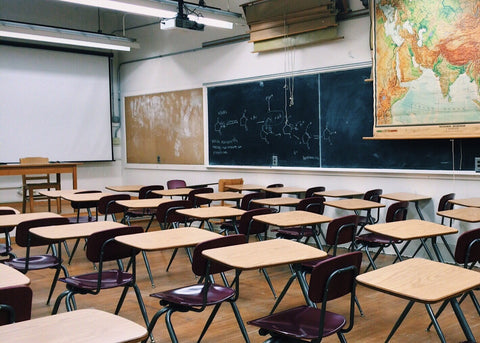 A classroom featuring a whiteboard and a chalkboard