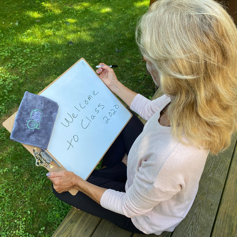 a teacher using a Think Board clipboard