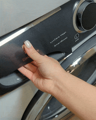 Laundry Leaf Detergent Sheet being placed in a detergent dispenser on a generic washing machine