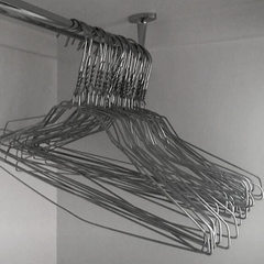 Wire hangers on wardrobe rail