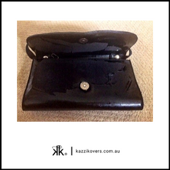 Black patent handbag which has peeled