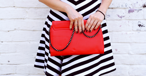Red handbag with model in chevron dress