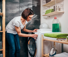 Lady choosing the washing machine cycle