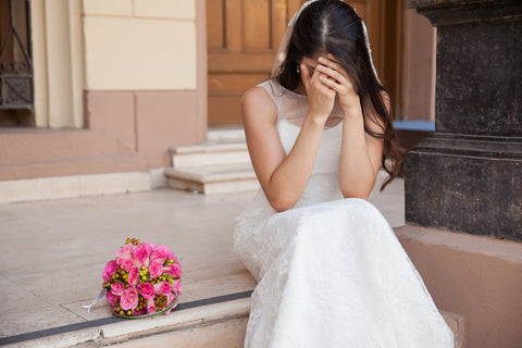 Sad bride on stairs