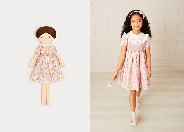 A young girl is standing in front of a plain background, holding a flower and wearing the Eloise dress. To the left, there is an ecommerce image of the Eloise doll.