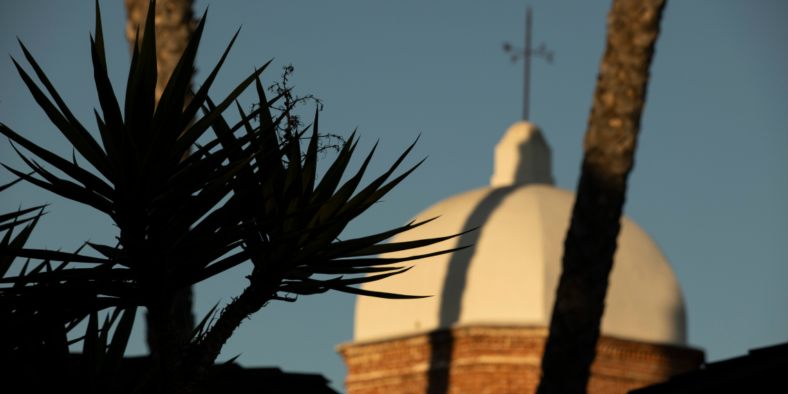 Evening descends over San Juan Capistrano, casting a tranquil glow as the remnants of sunset grace the sky, with a historic building along Los Rios Street standing elegantly in the background, capturing the charm of this quaint California town.