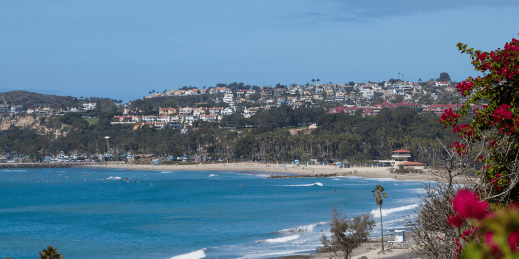 Doheny State Beach as seen from the picturesque viewpoint at Palisades Gazebo Park, offering a stunning coastal panorama.