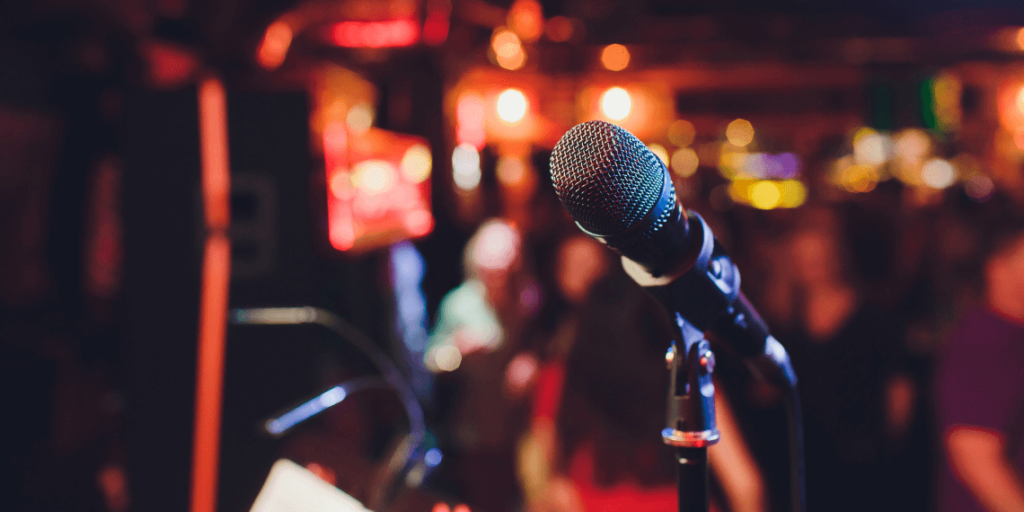 A close-up image of a microphone on the stage at The Coach House, setting the scene for live musical performances.