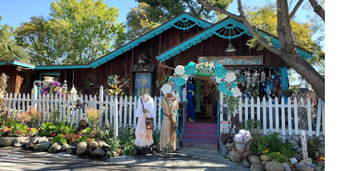 A colorful storefront adorned with vibrant displays and signage for Las Catrinas Store, situated on Los Rios Street.