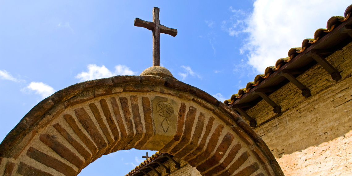 San Juan Capistrano Mission Cross and Archway: A timeless view of a stone cross framed by an ancient archway at the historic mission, symbolizing spirituality and history.