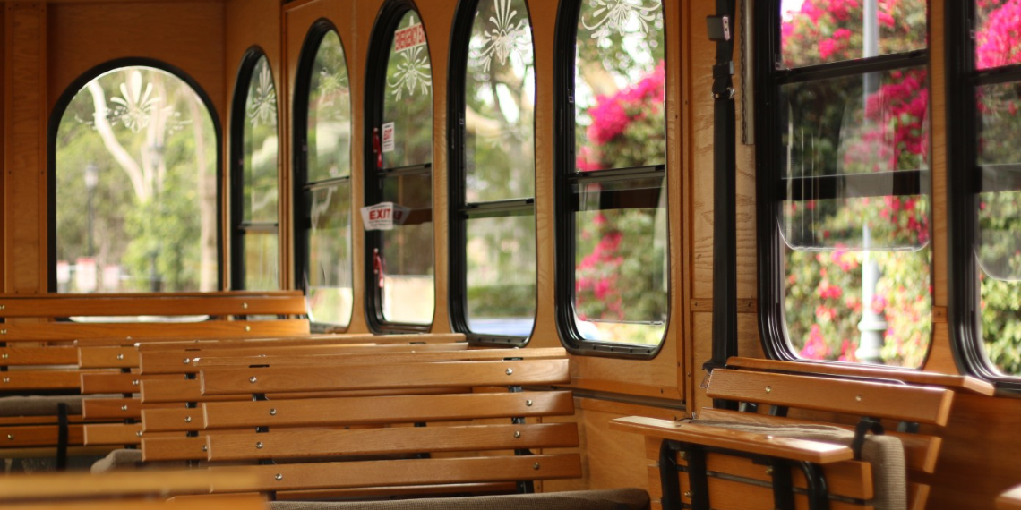 The interior of the San Juan Free Trolley, featuring a warm and inviting all-wood design, exuding a cozy and nostalgic ambiance for passengers.