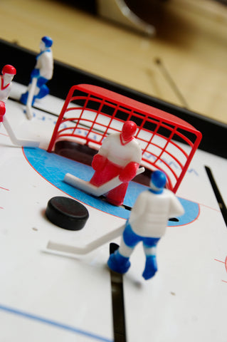 Close-up of dome hockey players on a Carrom dome hockey table.