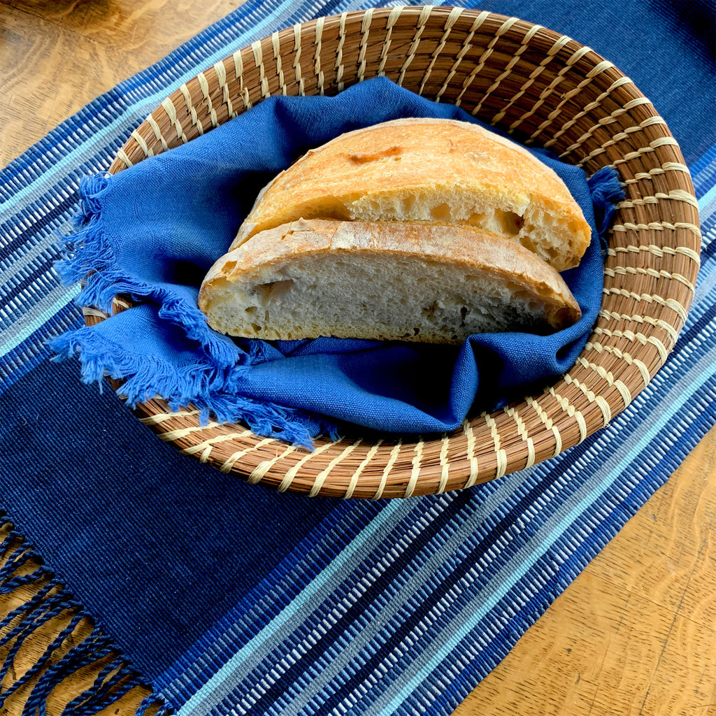 bread in mayan hands pine needle basket