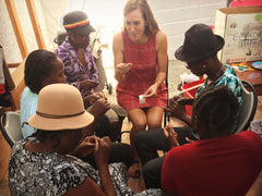 Madeline leading an embroidery workshop with women artisans in Haiti