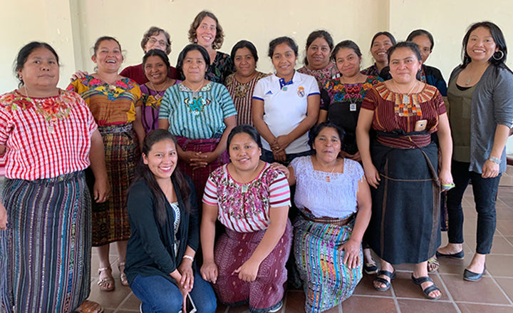 Mayan Hands workshop participants wearing jewelry they made