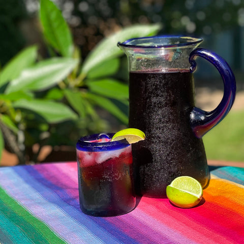 rosa de jamaica hibiscus tea in glass and pitcher and on handwoven tablecloth