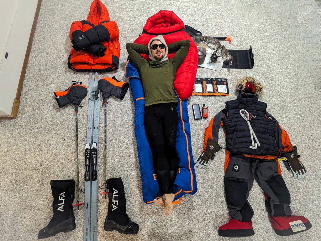 Jacob Valhalla Myers lies with his kit around him before departing for Antarctica.