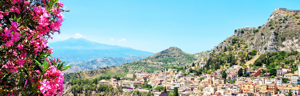 Beautiful Sunny Day In Taormina Looking Over the Town with Terracota Roof Tops and Mount Etna At The Back