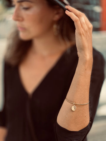 Unique and Handmade Bracelet with Pendant in Gold on Woman Wrist by What If You Stayed