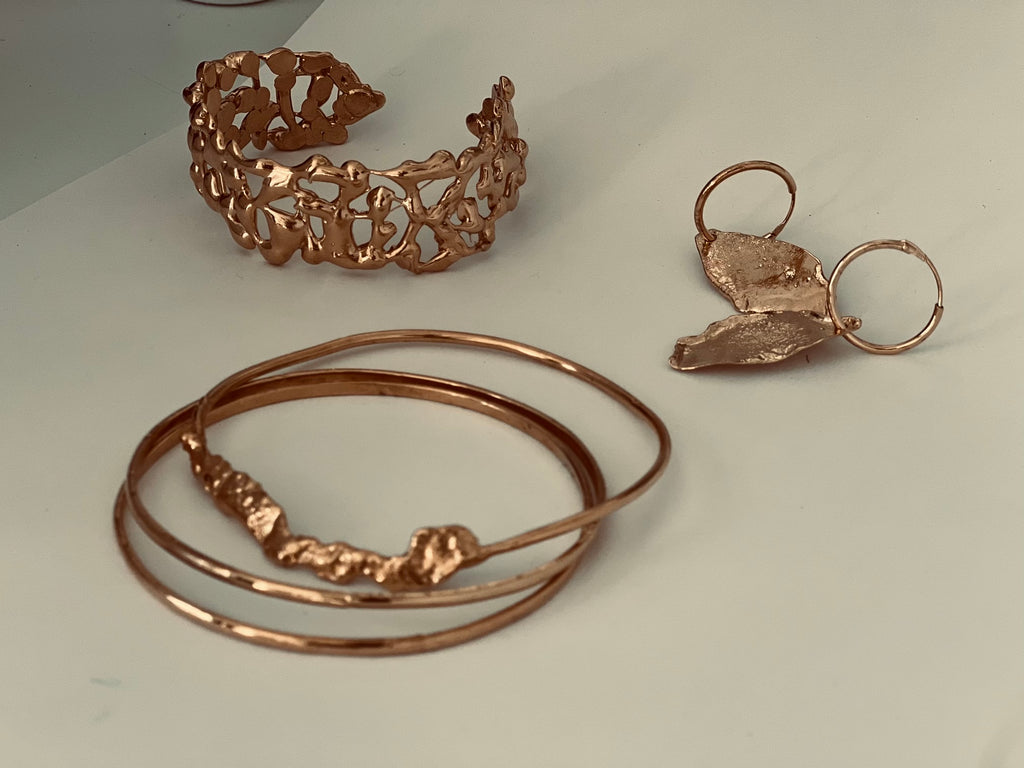Collection of handmade jewelry by What If You Stayed in Montreal, featuring a 14k gold filigree cuff bracelet, multi-bangle set, and a unique leaf-shaped earring