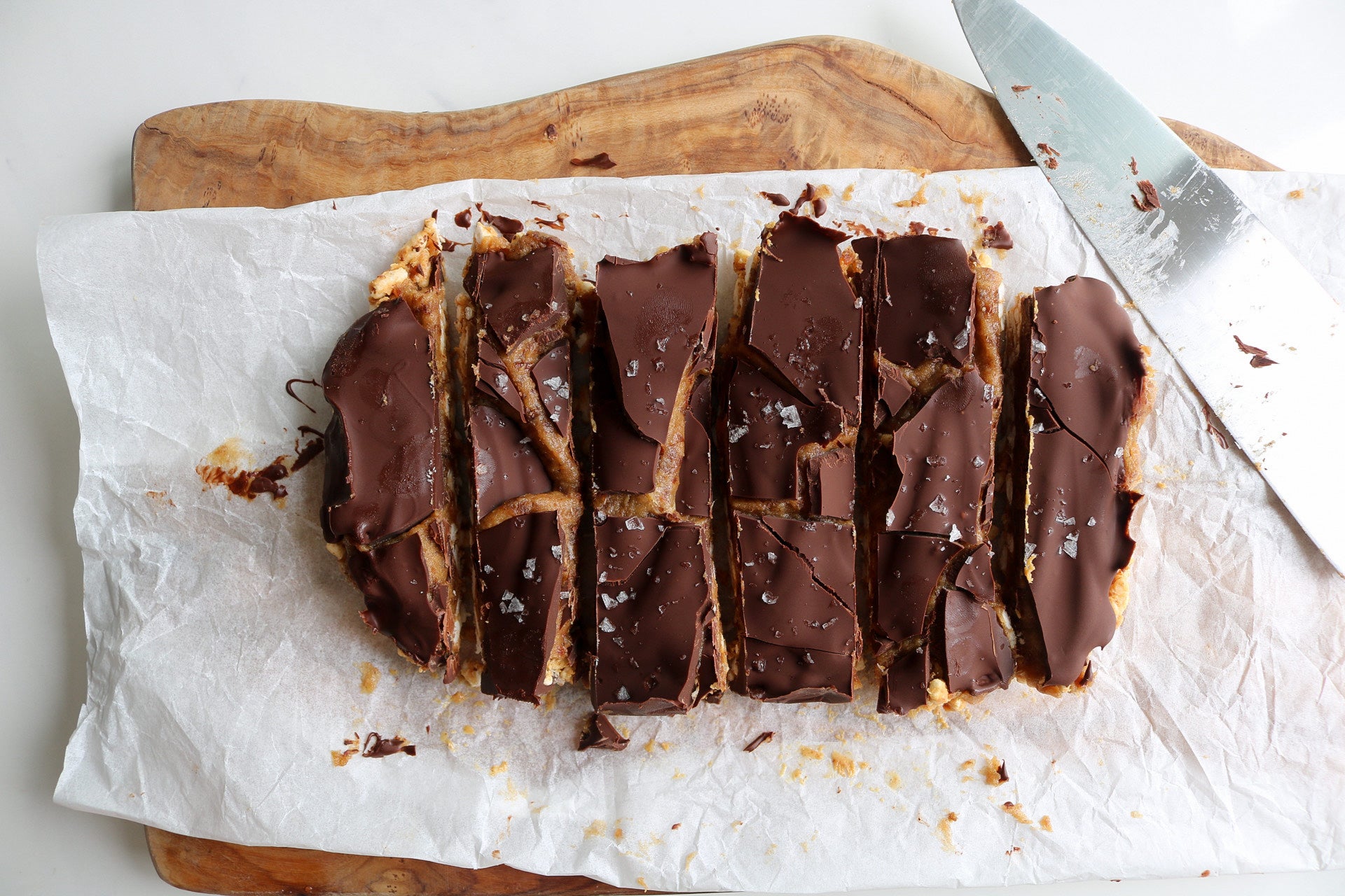 chocolate covered date caramel squares with puffed rice and peanut butter
