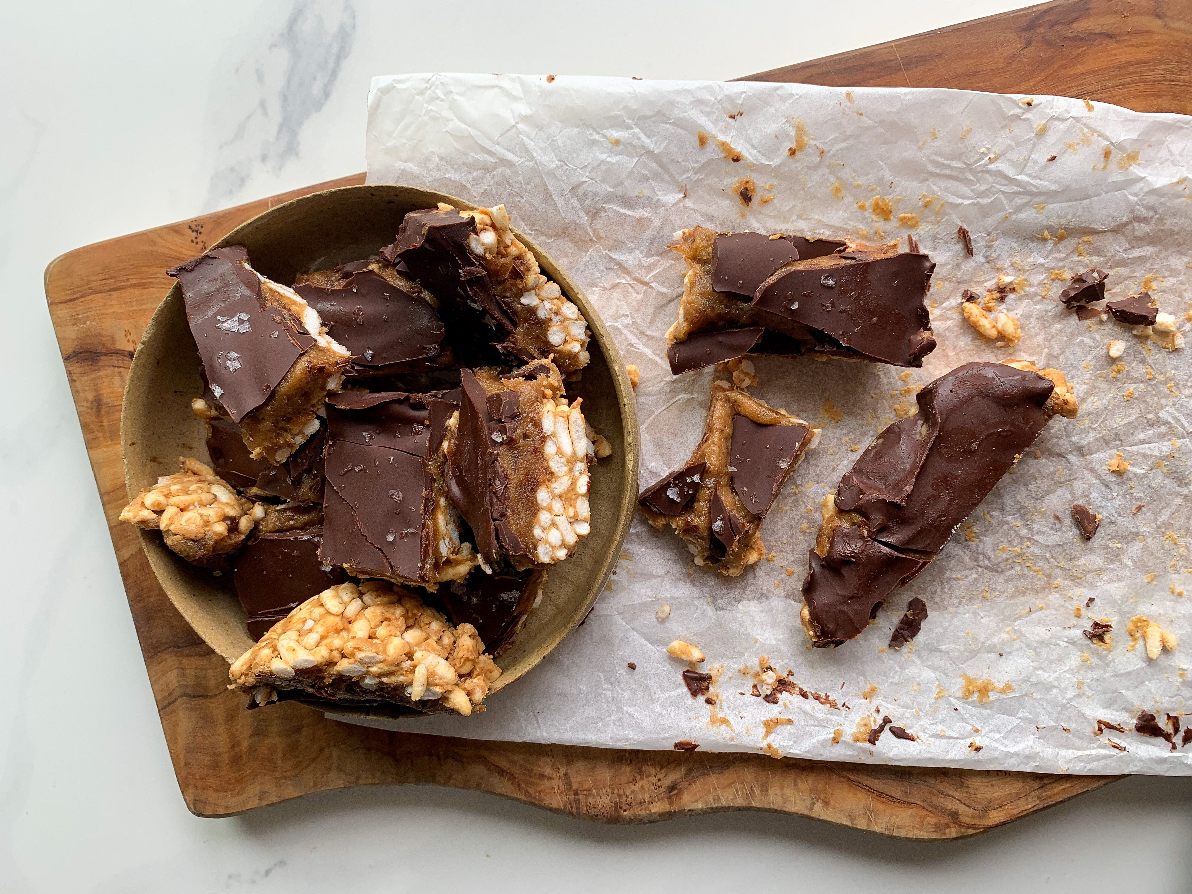 chocolate covered date caramel squares with puffed rice and peanut butter