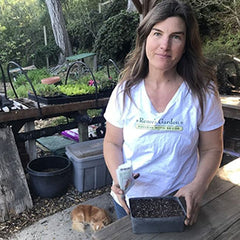 Lindsay with seeds in a container, her dog Emma in background