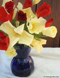 A bouquet of Tequila Sunrise poppies in a blue vase on a table with a white table cloth - Renee's Garden