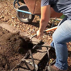 turning over soil with pitch fork