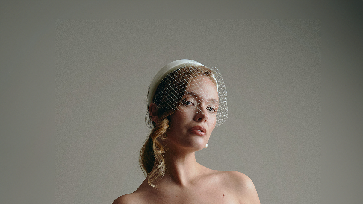 bride wears a birdcage veil padded headband