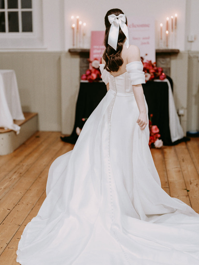 A white satin hair bow for a modern romantic bride