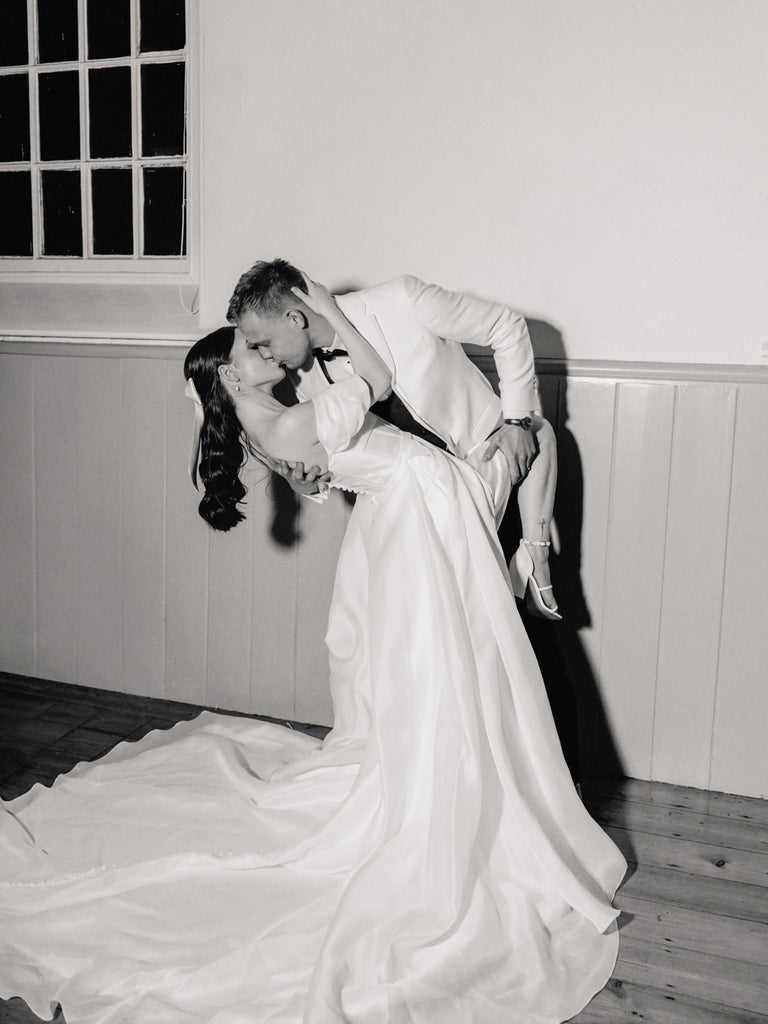 A white satin hair bow for a modern romantic bride and groom