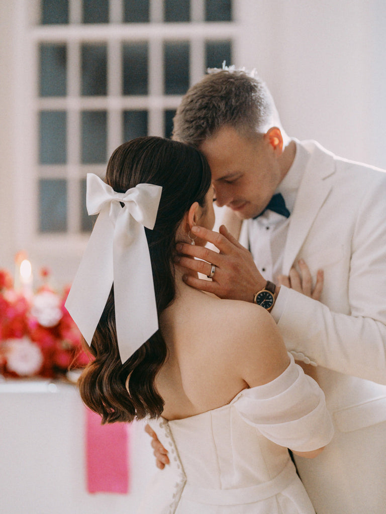 A white satin hair bow for a modern romantic bride and room