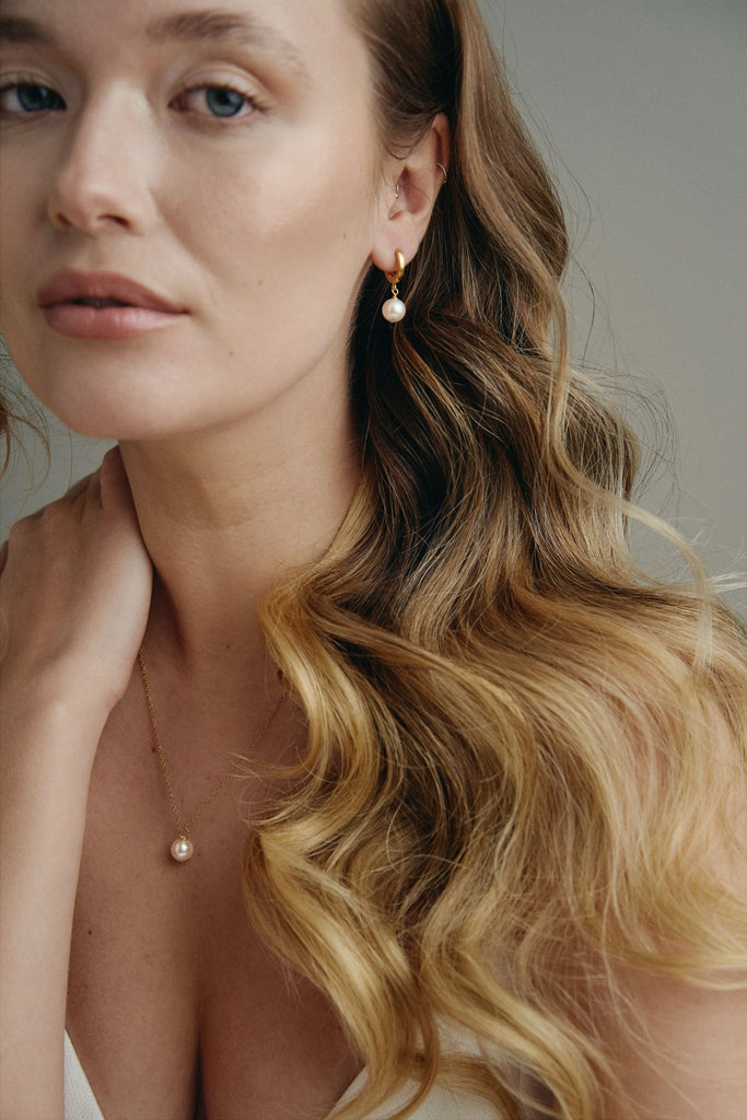 model wears modern simple pearl earrings and necklace