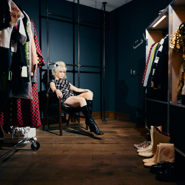 Paramore's Lead Singer, Hayley Williams, Sitting in a Chair in Full Glam