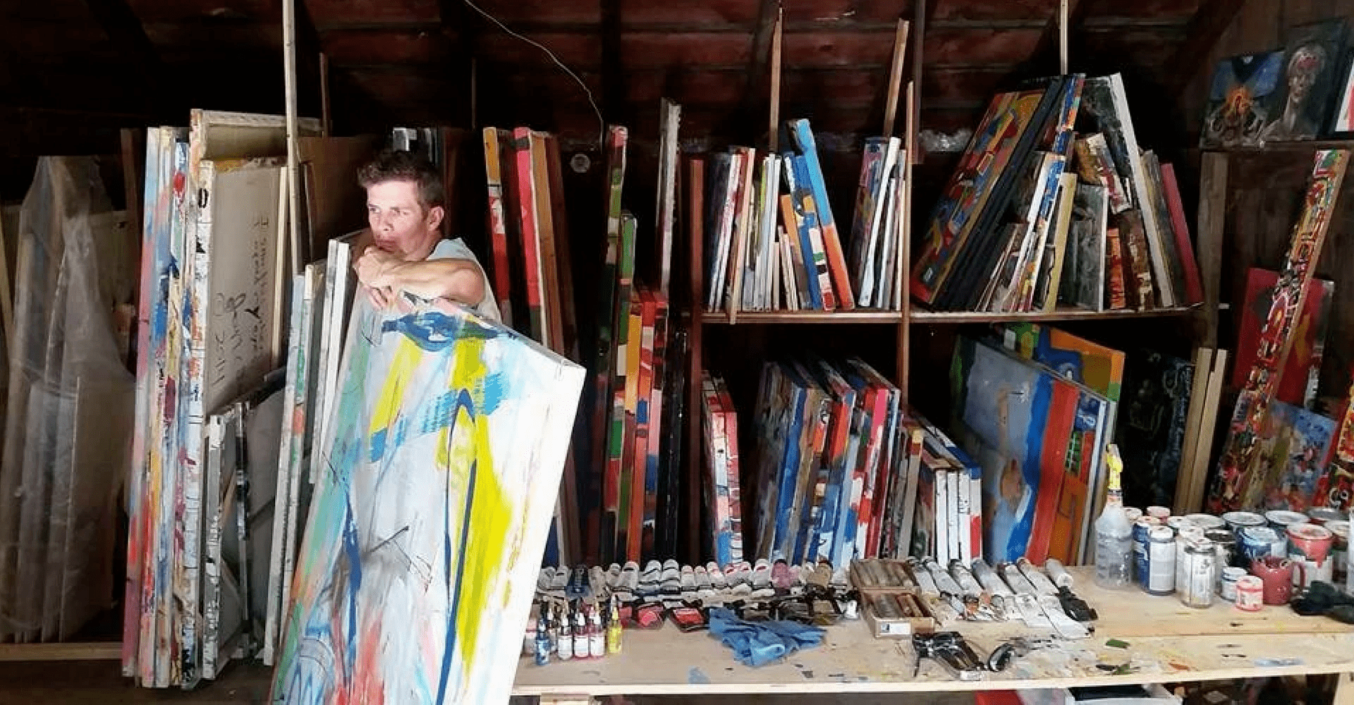 artist joseph ferm in studio with large canvasses